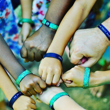 Support Humanity and Hope this Holiday Season with your purchase of this Hope Lives in Us Refocus Band.